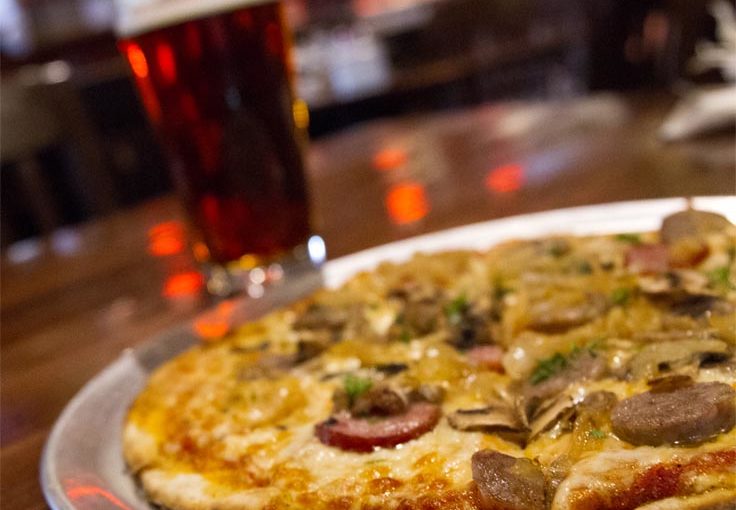 Three Sausage Pizza with beer